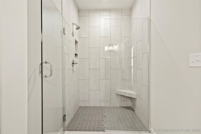 bathroom with a shower with shower door