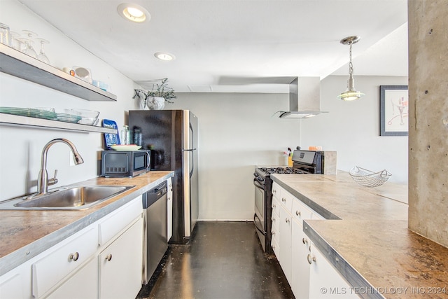 kitchen with white cabinets, appliances with stainless steel finishes, hanging light fixtures, and wall chimney exhaust hood