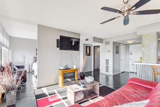 living room featuring a textured ceiling and ceiling fan