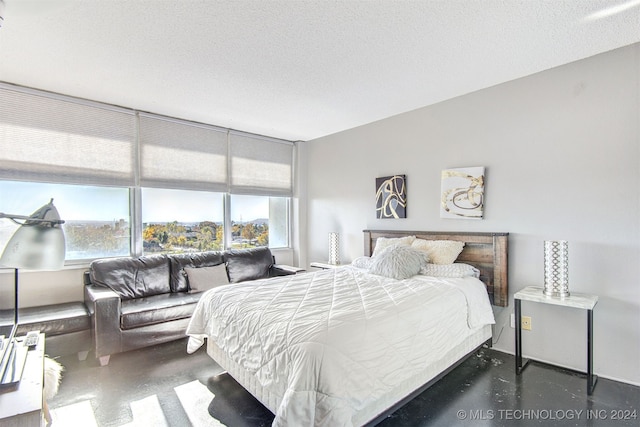 bedroom featuring multiple windows and a textured ceiling