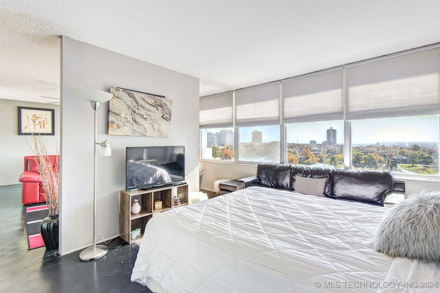 bedroom with concrete floors and a textured ceiling