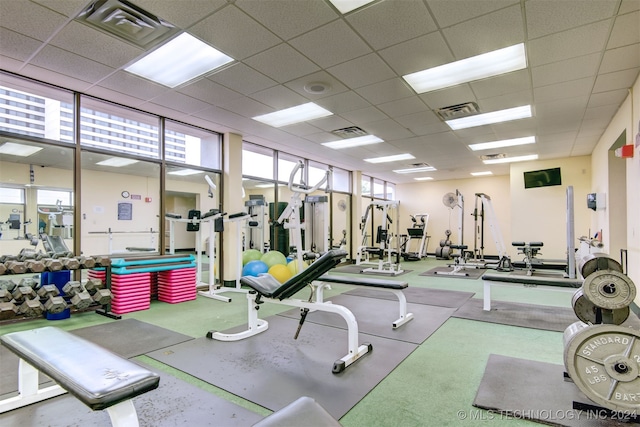 exercise room with a paneled ceiling