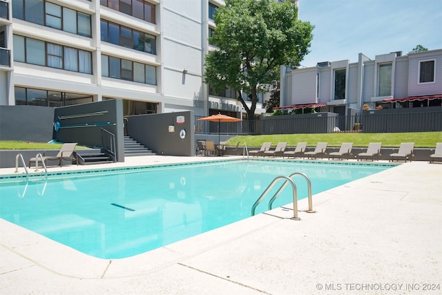 view of pool with a yard and a patio