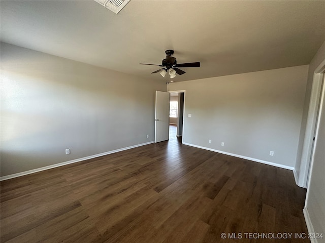 spare room featuring dark hardwood / wood-style floors and ceiling fan