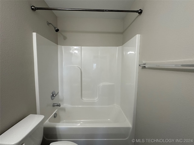 bathroom with tub / shower combination and toilet