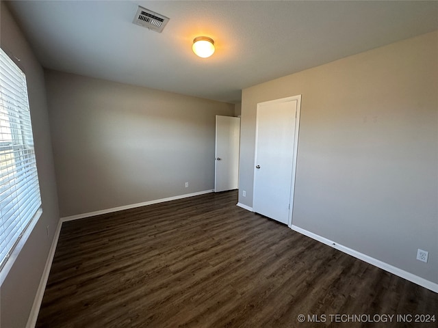 empty room with dark hardwood / wood-style floors