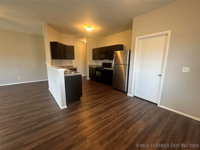 kitchen with stainless steel refrigerator, kitchen peninsula, dark hardwood / wood-style floors, and black gas range oven