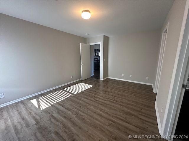 unfurnished bedroom featuring dark hardwood / wood-style flooring