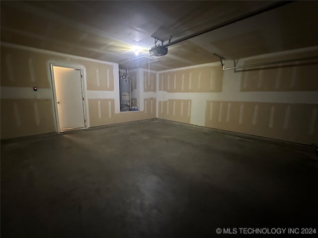 garage featuring water heater and a garage door opener