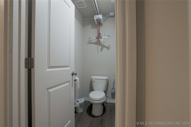 bathroom featuring toilet and hardwood / wood-style flooring