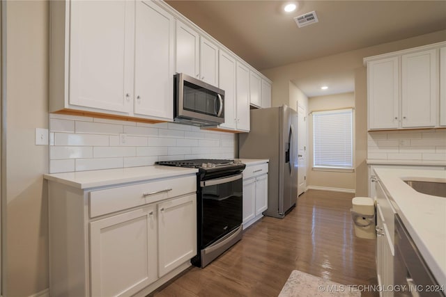 kitchen featuring white cabinetry, hardwood / wood-style floors, and appliances with stainless steel finishes