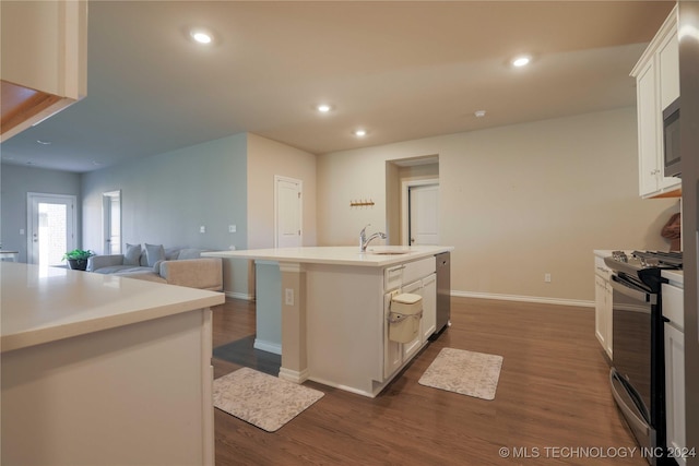 kitchen featuring white cabinetry, stainless steel range, sink, dark hardwood / wood-style flooring, and a center island with sink