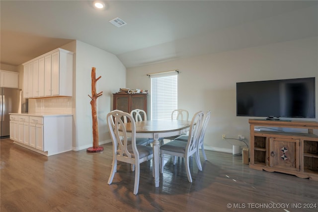 dining room featuring dark hardwood / wood-style floors and lofted ceiling