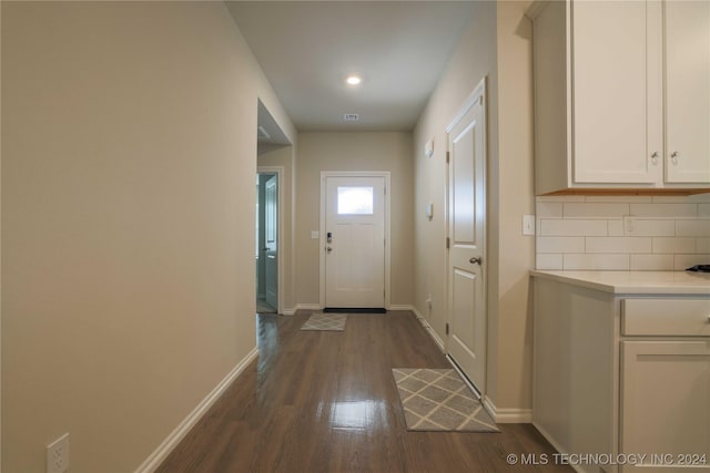 entryway with dark hardwood / wood-style flooring