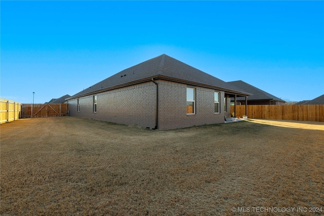 back of house with a lawn