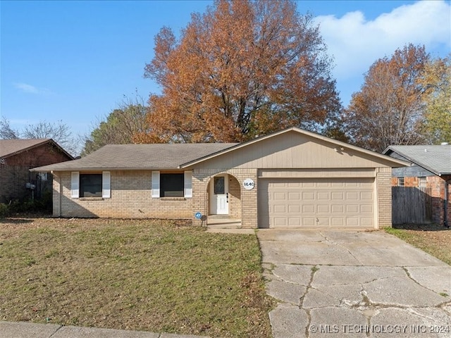 single story home featuring a garage and a front lawn