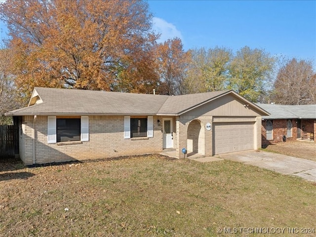 single story home featuring a front lawn and a garage