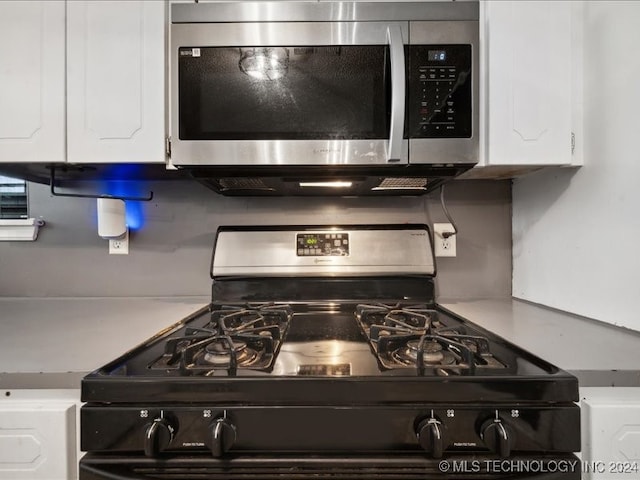 details featuring gas stove and white cabinets