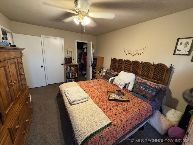 bedroom with carpet, ceiling fan, a textured ceiling, and a closet