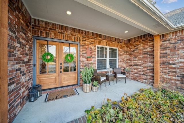 property entrance featuring covered porch and french doors