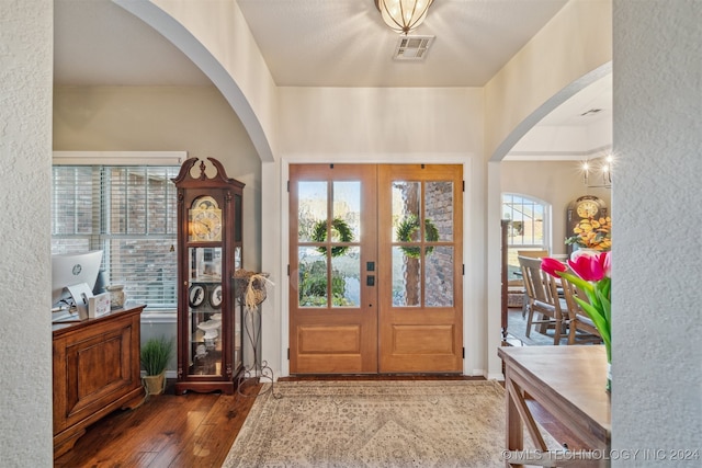 entryway with dark hardwood / wood-style flooring and french doors