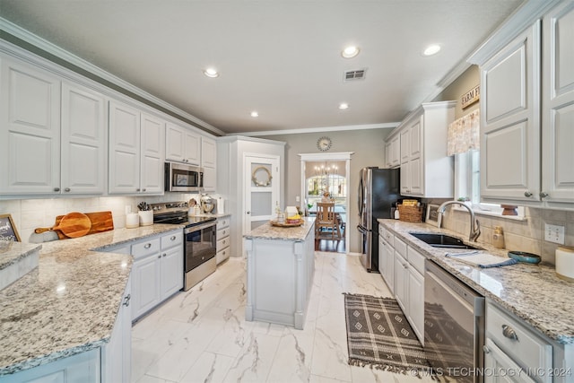 kitchen featuring white cabinetry, a center island, sink, and appliances with stainless steel finishes