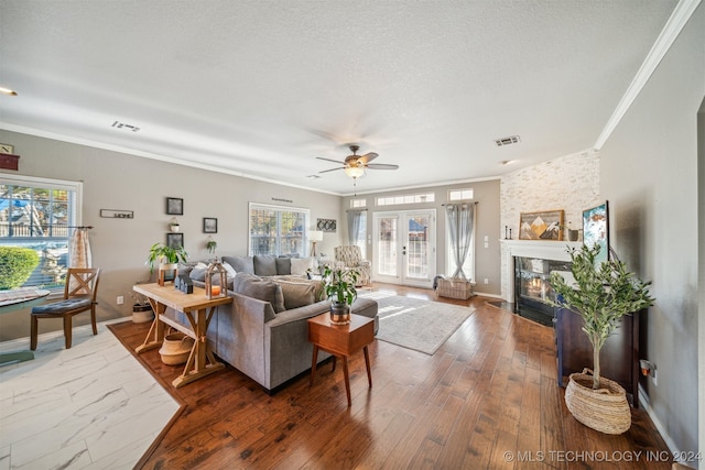 living room with plenty of natural light, ornamental molding, and hardwood / wood-style flooring