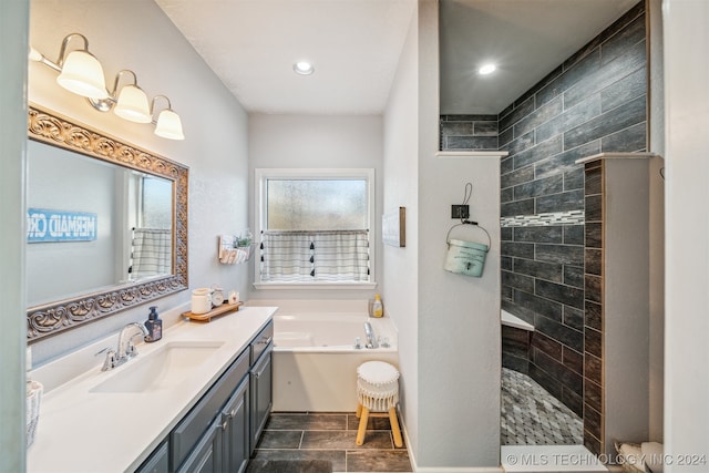 bathroom featuring tile patterned flooring, vanity, and plus walk in shower