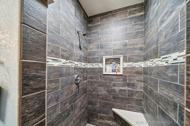 bathroom featuring tiled shower