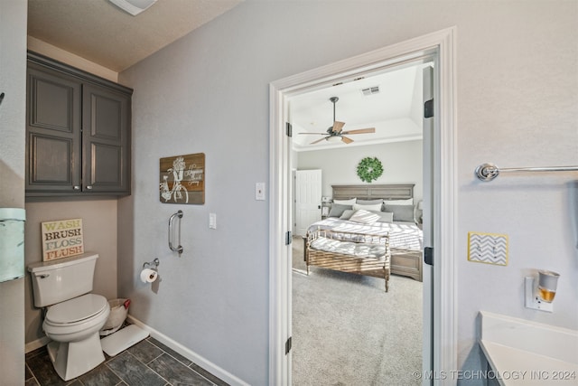 bathroom featuring ceiling fan and toilet