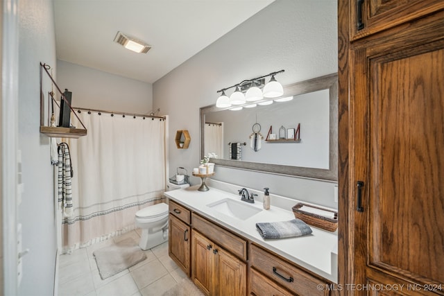 bathroom featuring toilet, vanity, and tile patterned floors