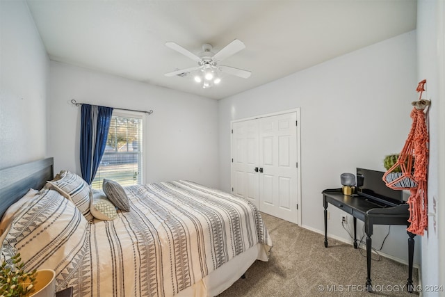 carpeted bedroom with ceiling fan and a closet