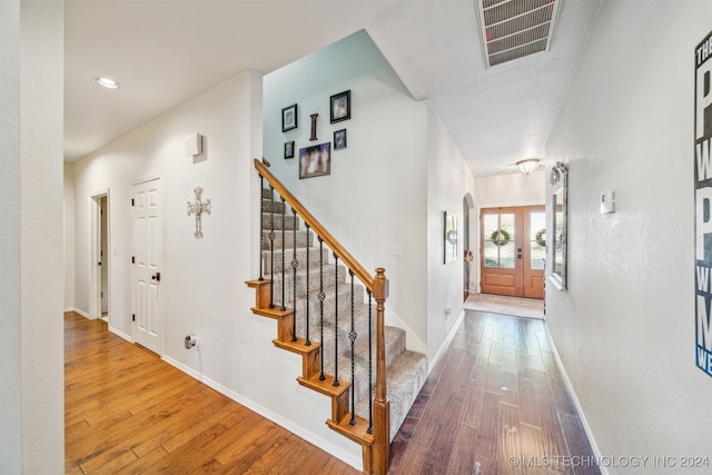 entryway with hardwood / wood-style flooring and french doors