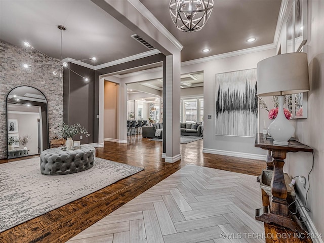 entryway featuring ceiling fan with notable chandelier, parquet floors, and ornamental molding