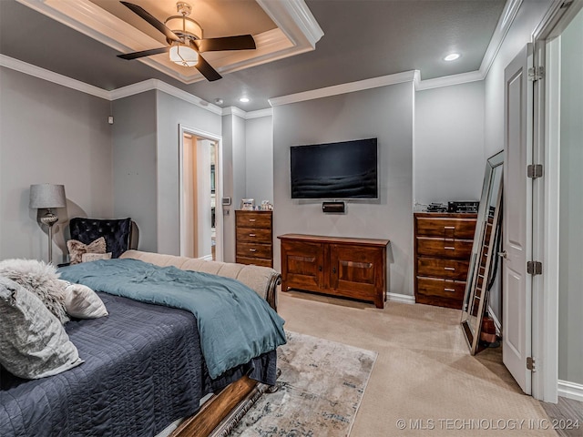 carpeted bedroom featuring a raised ceiling, ceiling fan, and ornamental molding