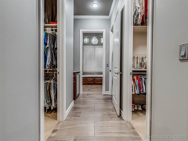 hall featuring light colored carpet and ornamental molding