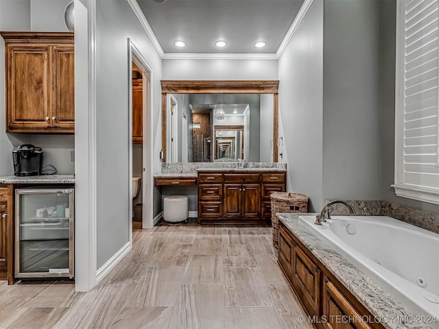 bathroom with beverage cooler, a tub to relax in, crown molding, toilet, and vanity