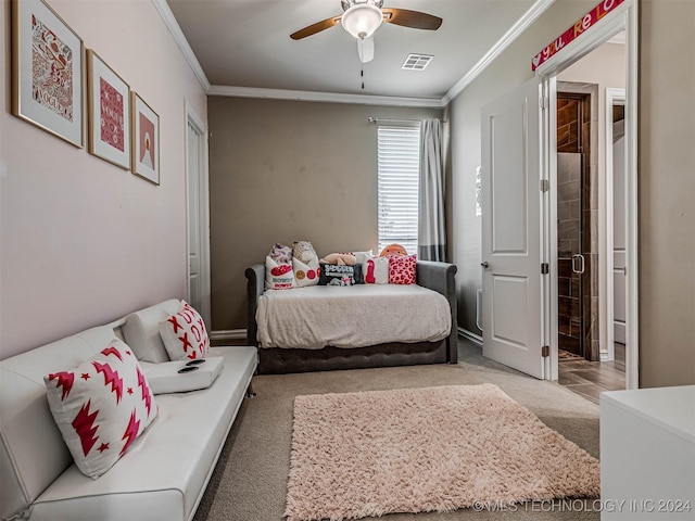 carpeted bedroom featuring ceiling fan and crown molding