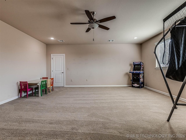 playroom with ceiling fan and light colored carpet