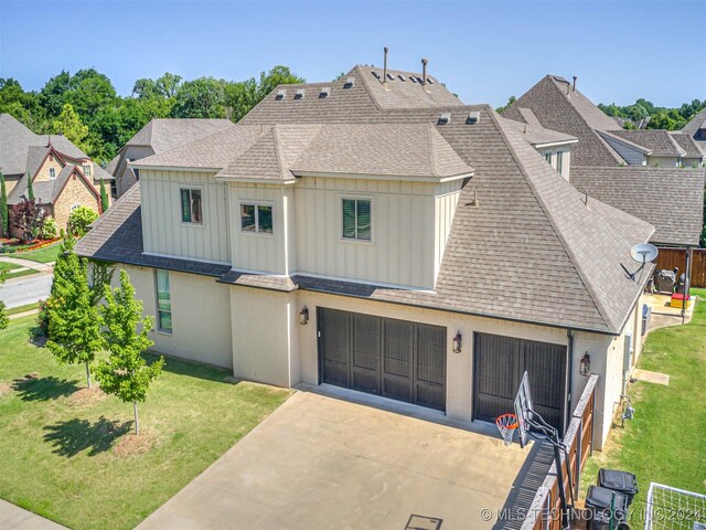 10673 S 93rd E Ave, Tulsa, OK 74133 - view of front of house with board and batten siding, driveway, a shingled roof, and a front yard