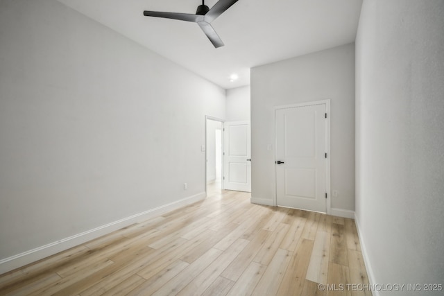 unfurnished bedroom featuring light wood-style flooring, baseboards, and ceiling fan