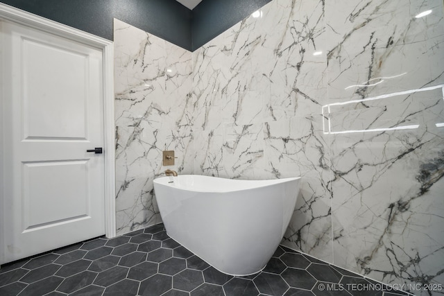 full bathroom with tile patterned flooring and a freestanding tub