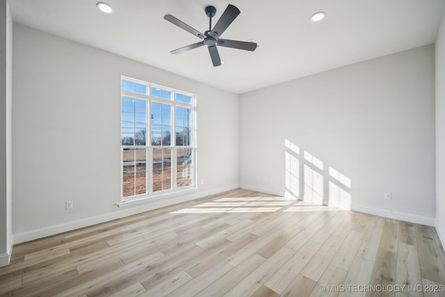 empty room with recessed lighting, light wood-style flooring, and baseboards