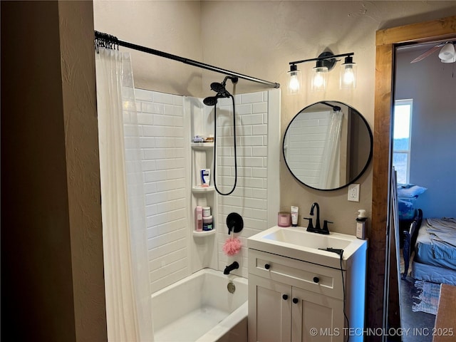 full bathroom with a textured wall, shower / bath combo with shower curtain, and vanity