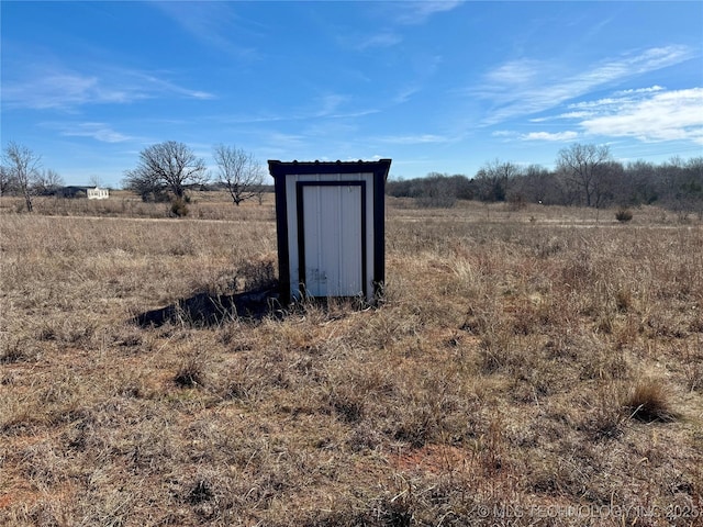 view of outbuilding with a rural view