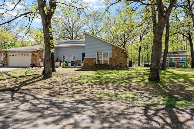 view of front of property with a garage and a front lawn