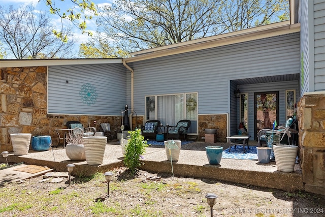 back of property featuring a patio