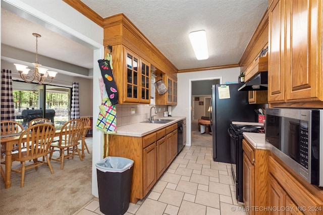 kitchen with tasteful backsplash, sink, black appliances, an inviting chandelier, and hanging light fixtures