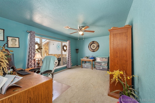 carpeted home office featuring ceiling fan and a textured ceiling