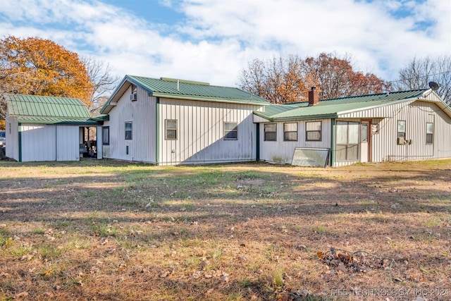 rear view of house with a lawn